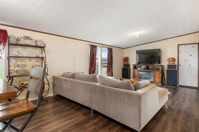 Living room with lofted ceiling, dark hardwood / wood-style flooring, and ornamental molding | Image 2