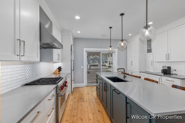 Beautifully appointed kitchen includes stainless appliances plus added bonus of a steam oven and mini-wine chiller with freezer. | Image 10