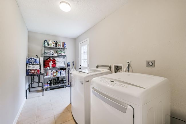 The utility room is enormous and conveniently has access to the back yrad. | Image 22