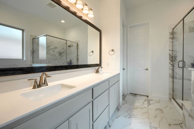 Bathroom with marble finish floor, a sink, a marble finish shower, and double vanity | Image 18