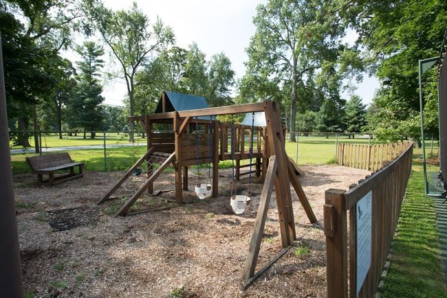 View of playground with a yard and fence | Image 22
