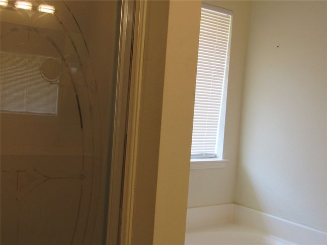 Bathroom with a bath and walk in shower | Image 21