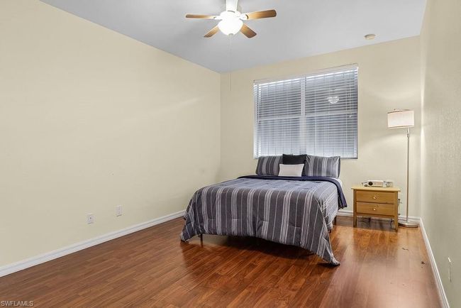 Bedroom featuring a ceiling fan, baseboards, and wood finished floors | Image 20