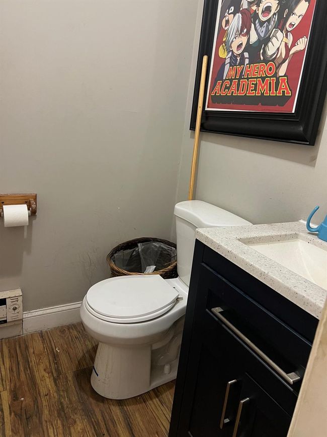 Bathroom featuring hardwood / wood-style flooring, vanity, and toilet | Image 6