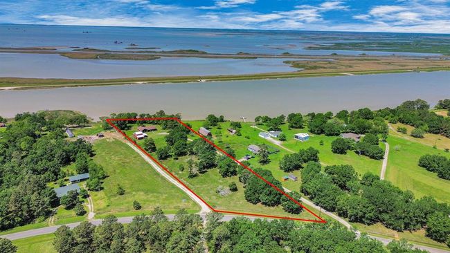 Enjoy sun and shade on this tremendous property overlooking the bay. You can build your own fishing pier and dock! | Image 34