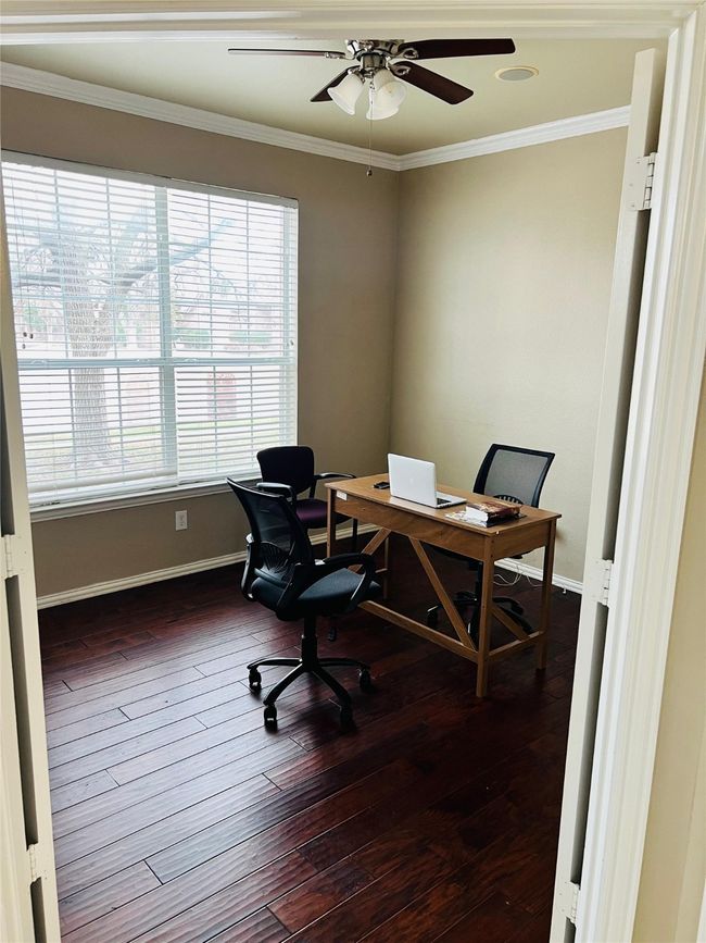 Office with dark wood-type flooring, ceiling fan, and crown molding | Image 6