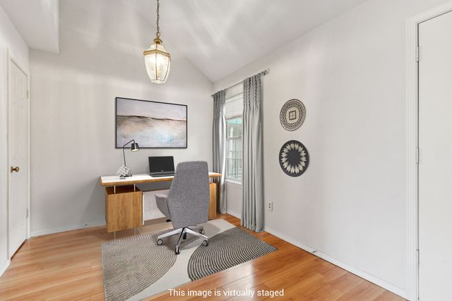Office space with light wood-style floors, vaulted ceiling, and baseboards | Image 23