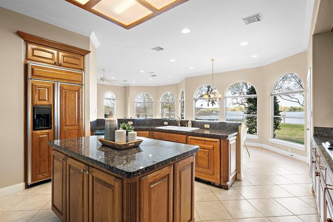 The kitchen has an open vista onto the breakfast and living areas, making it easier for the host to mingle while entertaining. | Image 19