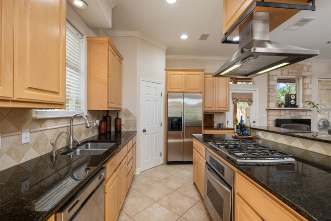 The kitchen functions as a galley-style with the pantry and frig on one end. | Image 7