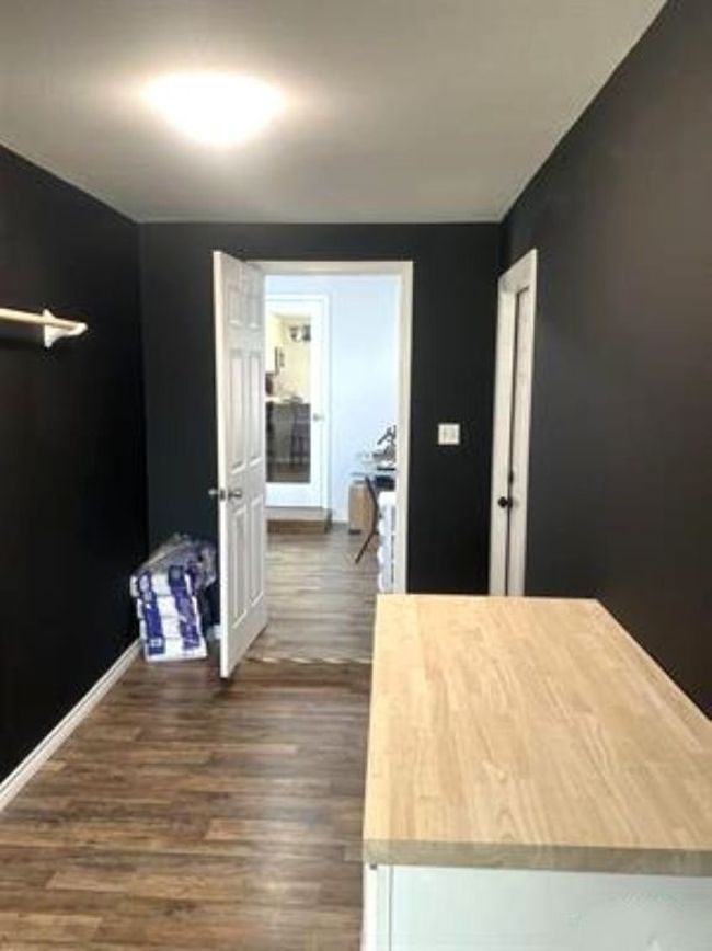 Hall with baseboards and dark wood finished floors | Image 18