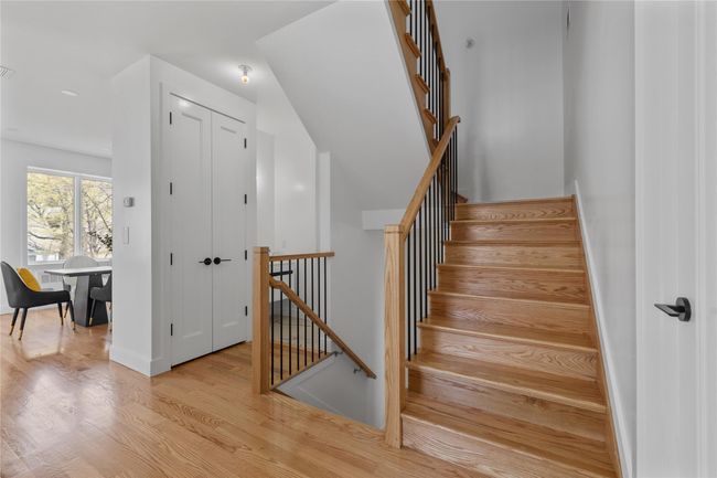 Staircase featuring baseboards and wood finished floors | Image 6