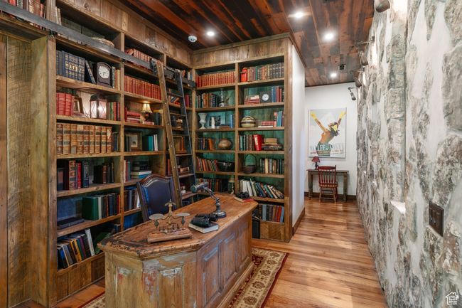 Home office with bookshelves and wood finished floors | Image 27