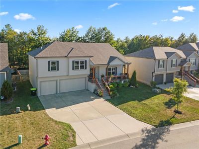 View of front of property with a garage, covered porch, and a front lawn | Image 2