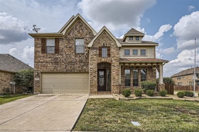 View of front facade featuring a garage and a front lawn | Image 1