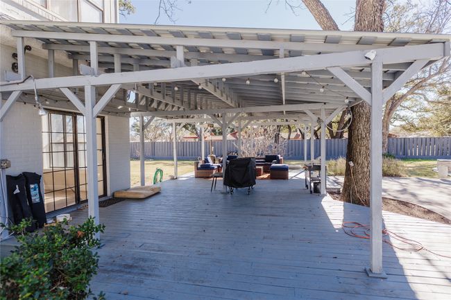 Wooden terrace featuring an outdoor fire pit | Image 39