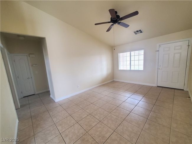 Unfurnished room featuring vaulted ceiling, visible vents, a ceiling fan, and light tile patterned floors | Image 7
