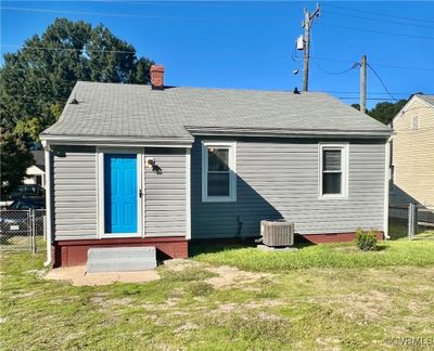 Rear view of property with cooling unit and a lawn | Image 3