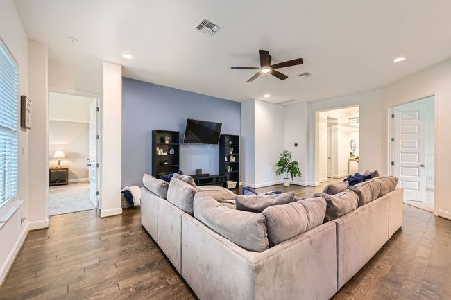 Living room featuring dark wood-style flooring, a ceiling fan, and recessed lighting | Image 8