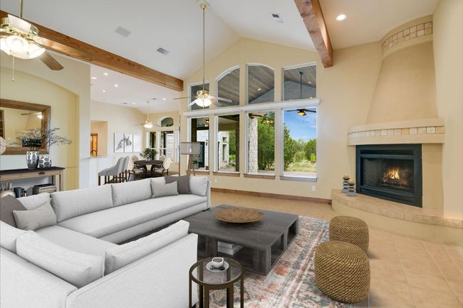 The same room with a view through the back windows to the outer sanctum. The virtual staging will give you an idea of the blending of the living and either dining area. There are electric shades on these windows, as well. This is a gas fireplace w/ a circulatory fan. Spot lighting enhances the mood you will want to create! | Image 8