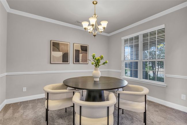 Dining room featuring a chandelier, carpet floors, baseboards, and ornamental molding | Image 12