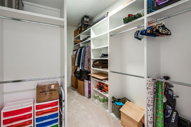 Huge closet of th primary bedroom with builtin shelves | Image 26