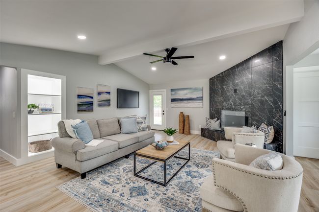 Living area featuring light wood-style floors, a ceiling fan, and recessed lighting | Image 6