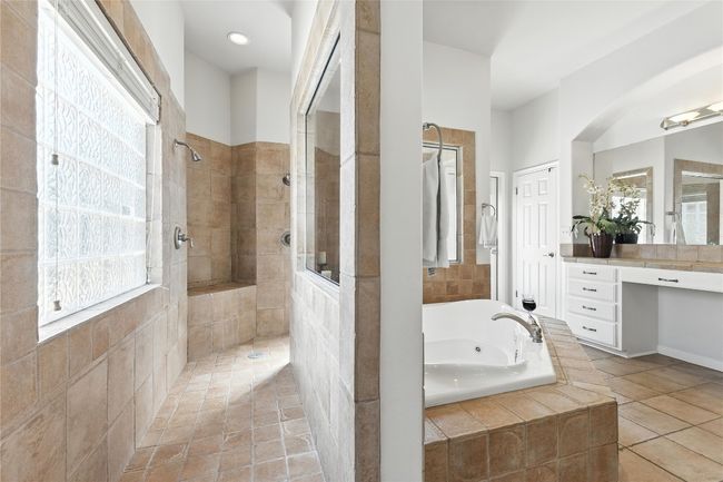 Full bath featuring a bath, a walk in shower, and healthy amount of natural light | Image 23