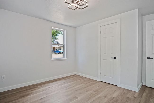 Spare room featuring light wood-style floors and baseboards | Image 9