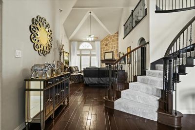 Foyer entrance with dark hardwood / wood-style floors, ceiling fan, and high vaulted ceiling | Image 2