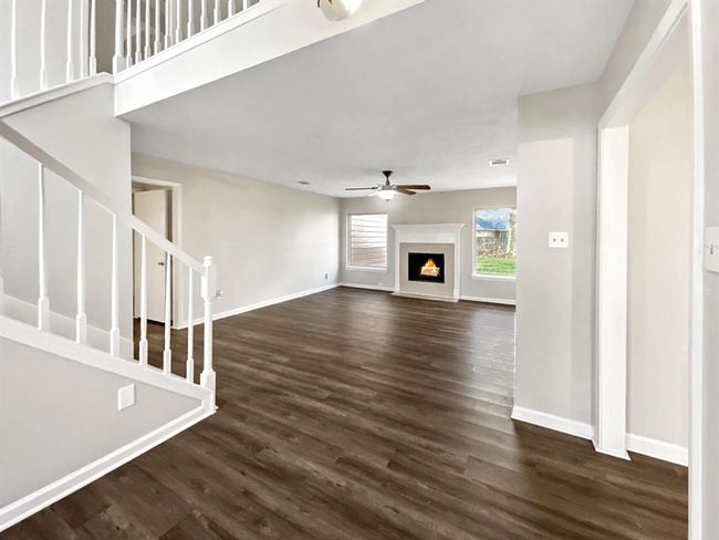 Spacious living room with wood-burning fireplace. | Image 5