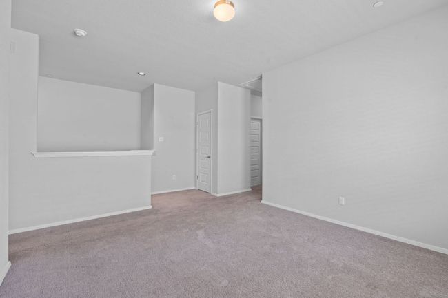 Carpeted empty room featuring a smoke detector and recessed lighting | Image 16