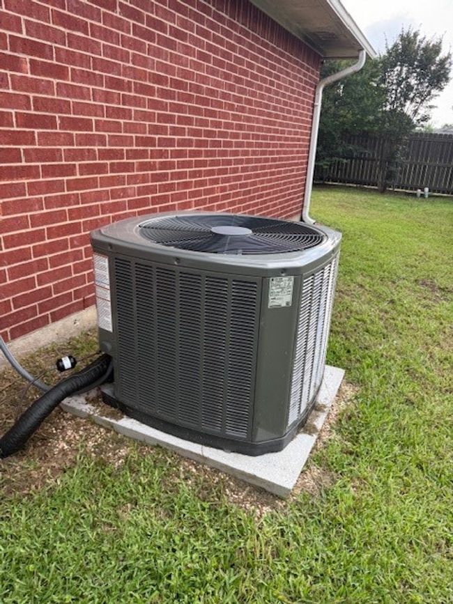 Exterior view of central air condition unit and brick siding | Image 10