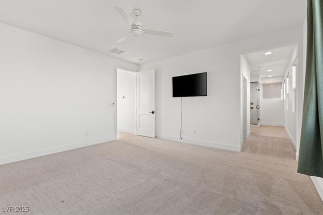 Empty room featuring baseboards, visible vents, light carpet, and a ceiling fan | Image 35