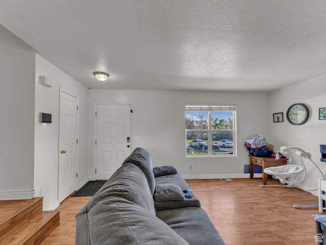 Living room featuring wood finished floors and baseboards | Image 9