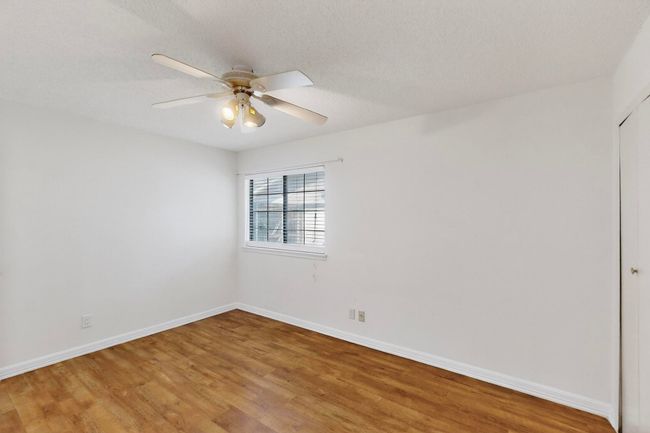 Spare room featuring light wood-style floors and ceiling fan | Image 19