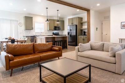 Living room featuring sink and light hardwood / wood-style flooring | Image 2