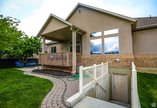 Back of house featuring brick siding, stucco siding, and a patio area | Image 38