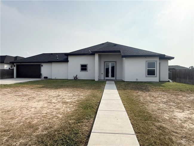 Prairie-style home with french doors, roof with shingles, a garage, concrete driveway, and stucco siding | Image 19