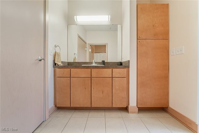 Full bathroom with vanity, tile flooring, and plenty of storage. | Image 30