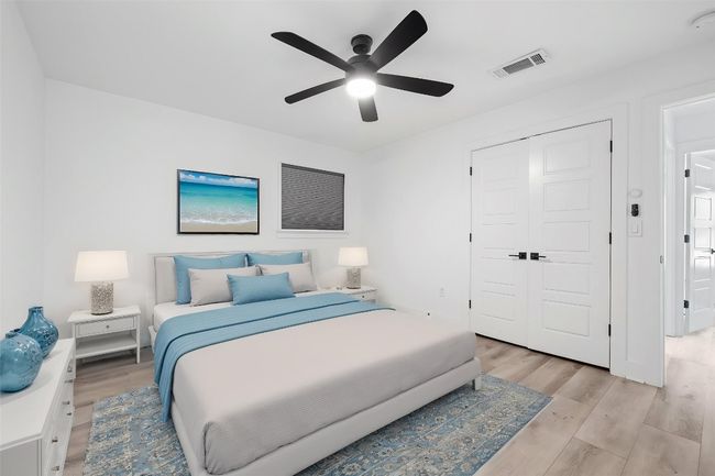 Bedroom featuring light wood finished floors, visible vents, a closet, and ceiling fan | Image 23