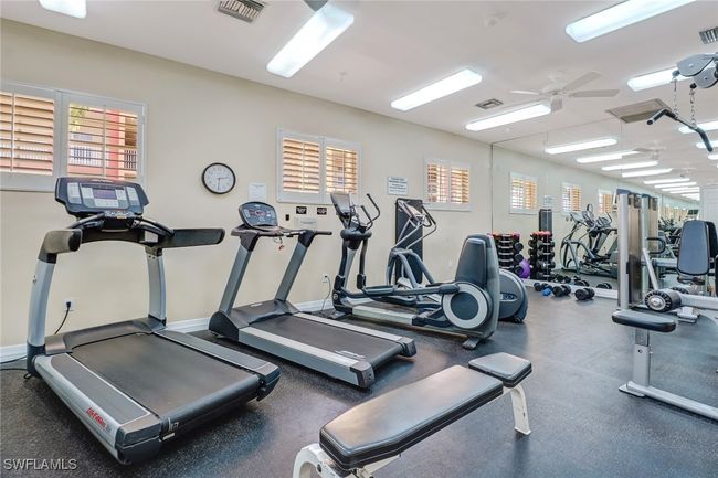 Exercise room featuring ceiling fan and baseboards | Image 20