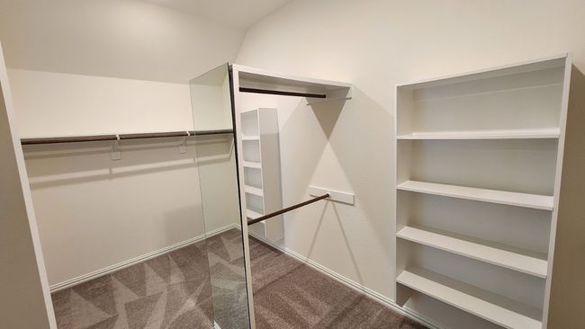 Walk in closet with dark carpet | Image 24