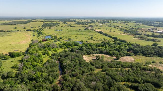 Aerial view from the South side of the property. You can see Kickapoo Creek which runs along and through the property line. | Image 16
