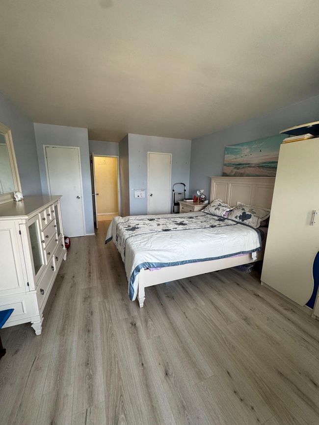 Bedroom with wood finished floors | Image 6