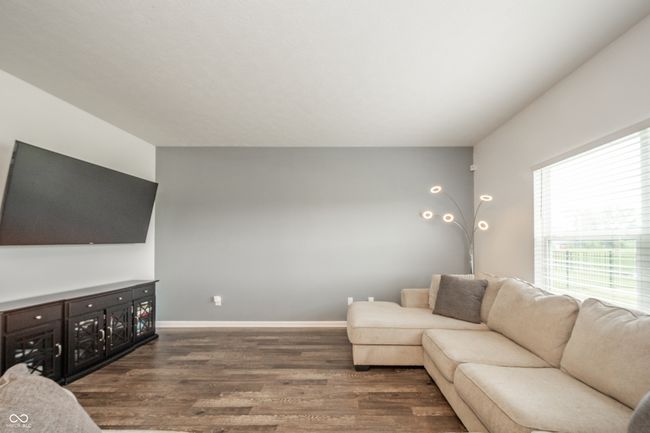 living area with dark wood-type flooring and baseboards | Image 9
