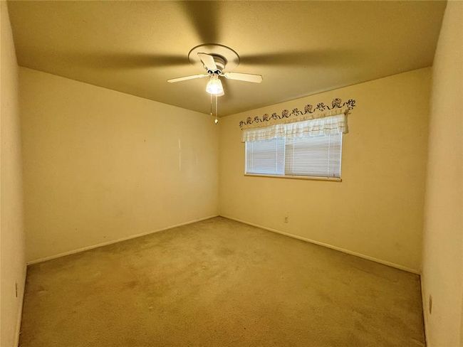 Unfurnished room with carpet floors and ceiling fan | Image 32