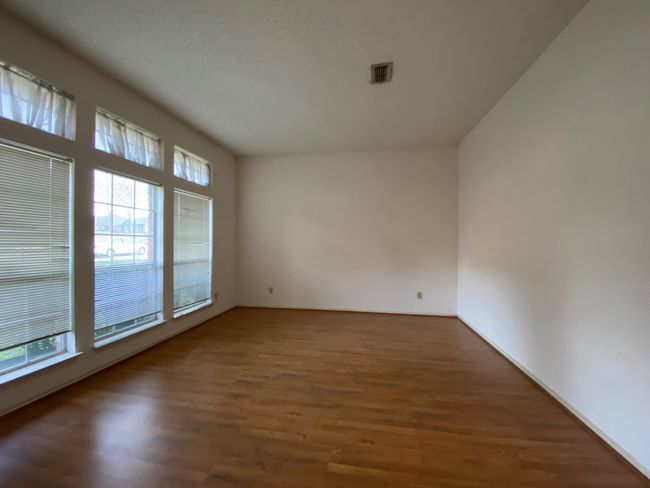 Spare room featuring wood finished floors and baseboards | Image 5