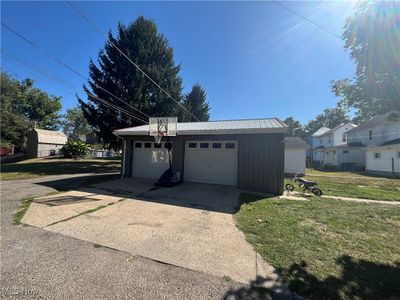 Garage featuring a yard | Image 2