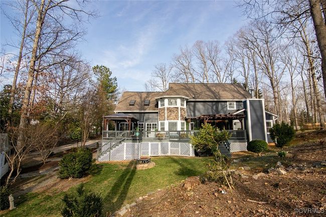 Rear view of property featuring stairway, a lawn, and a wooden deck | Image 41
