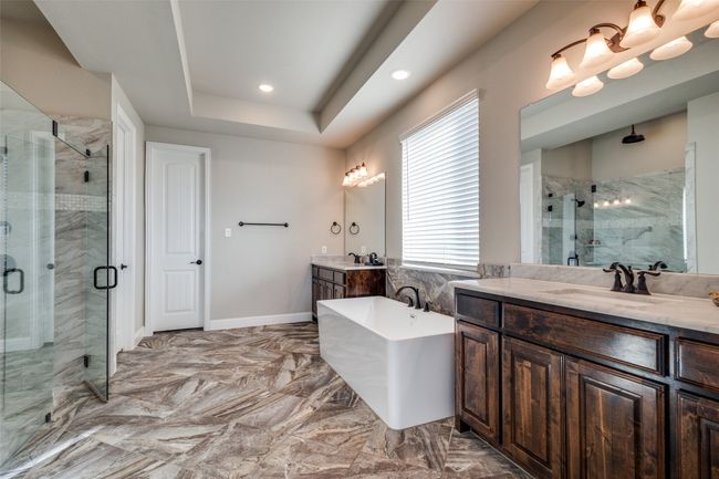 Bathroom featuring vanity, plus walk in shower, and a tray ceiling | Image 20